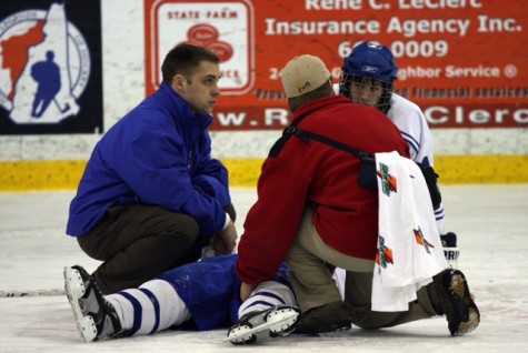 New heard coach, Dan Legro tends to an injured player of his former team.