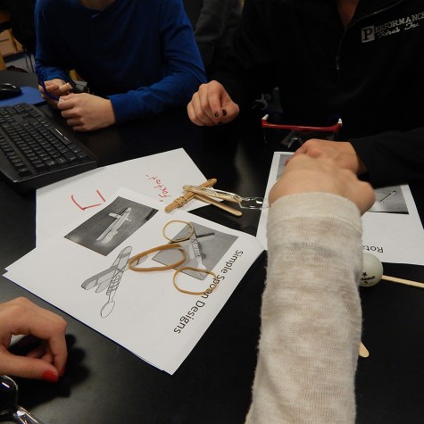 Students were given a packet of catapult designs, and worked together to recreate these designs using specific materials, such as popsicle sticks and rubber bands.