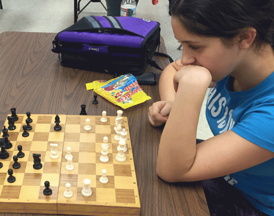 Junior Ariana Simard contemplates her next move during a chess club meeting.