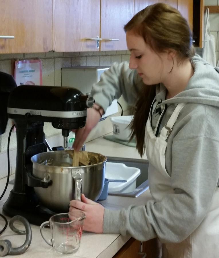 Junior Hannah Donahue uses a professional Kitchenmaid mixer to prepare a dish in culinary club.