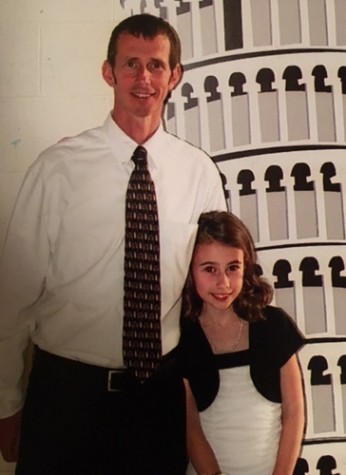 Mr. Milne and his daughter enjoy their time at a father daughter dance.