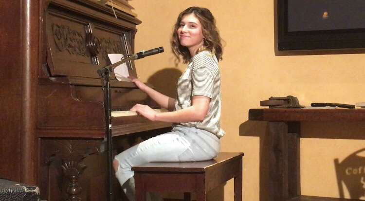 During an open mic, McRitchie plays a set at The Coffee Factory in Derry. McRitchie began playing piano at the end of third grade, for which she took lessons. She also took lessons for guitar, but not for ukulele.