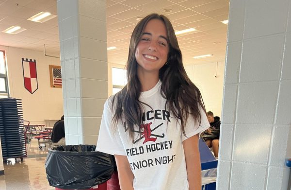 Sophomore Alison Chambers smiles in the cafeteria while showing off her outfit for day.