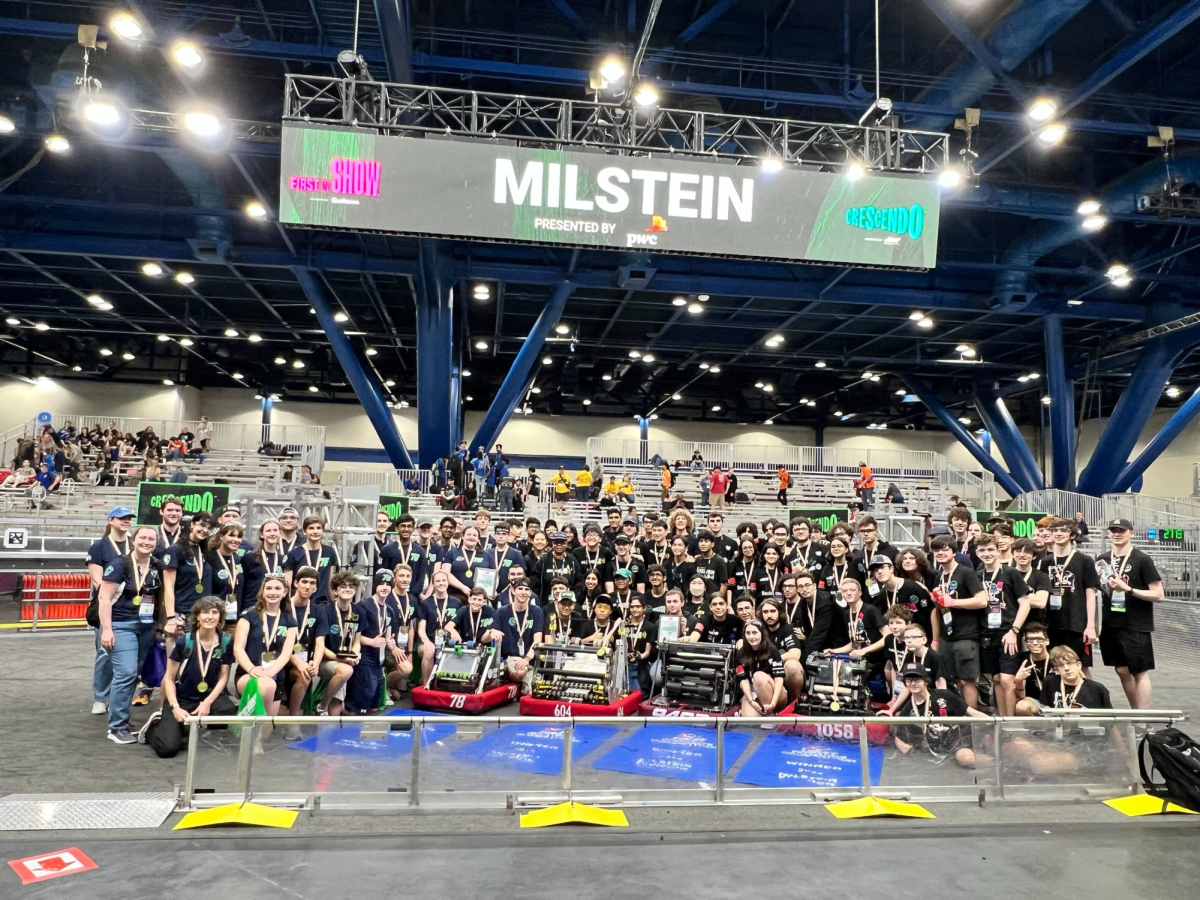 The Milstein Division winners (including the LHS Robotics team) pose on the Crescendo game field.