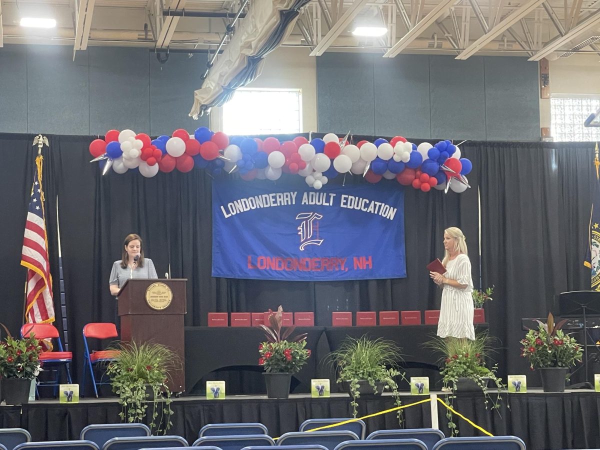 Mrs. Burkhart and Mrs. Rich proudly announce adult education graduates to come forth to the stage to receive their diplomas. 
