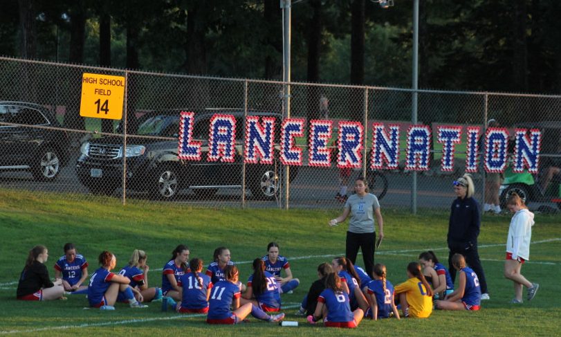 The girls sit in a group as the coaches are talking to them. (Photo used with permission from Abby Jones.)