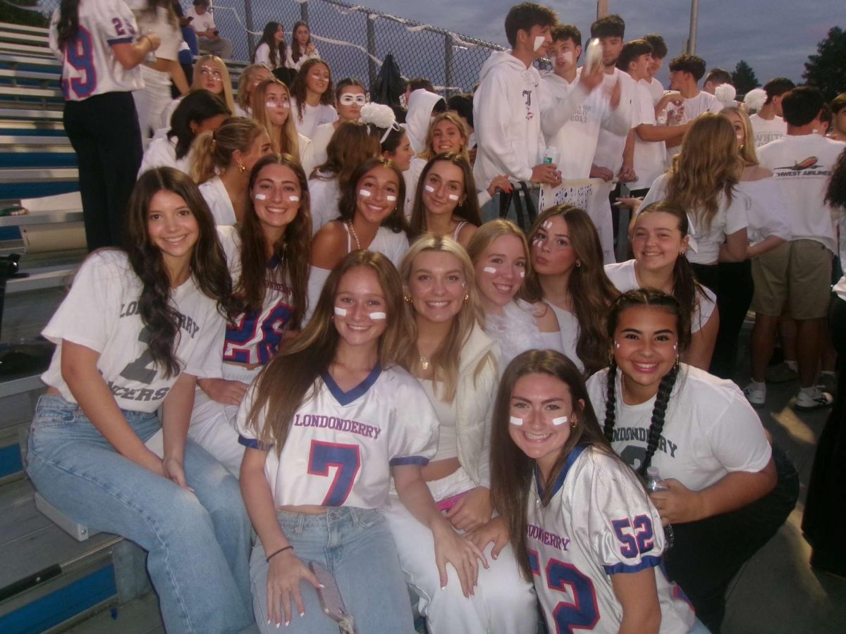 A group of senior girls in the student section, spirited, and ready to cheer on the Lancers!