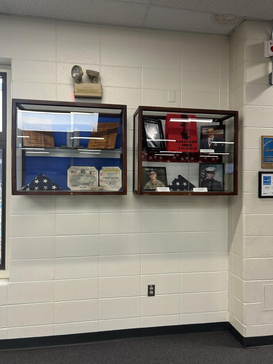 The glass display is filled with many different items that the Blue Star Lancers have put together.