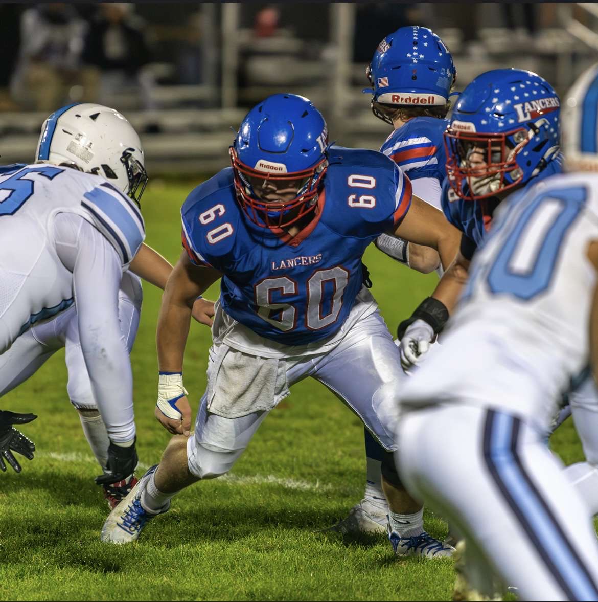 Senior Cody Gray goes to make a tackle in a game against Nashua North High School in a 61-42 Lancer win on October 18th. (Photo by Charlie Ogden)