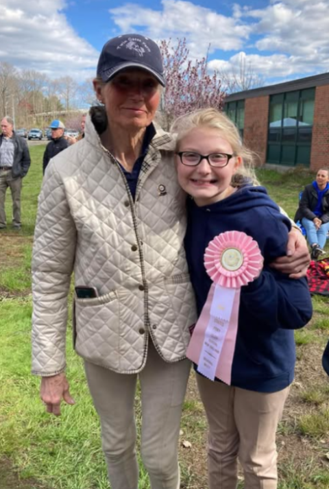 Darcy Newman embraces one of her students after a competition called “quiz rally”. The purpose of this competition is to test riders on their knowledge of everything horse related.