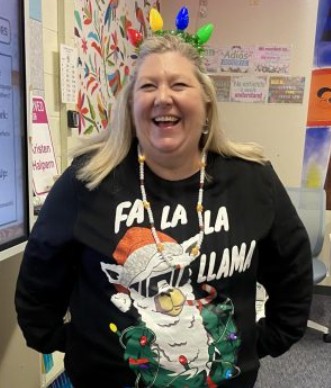 Señora Halpern shines bright for teacher’s spirit day. Her festive outfit lights up the classroom with holiday cheer. 