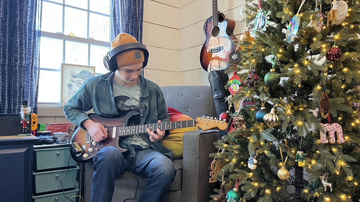 Junior Ben Bristol helps teach students different elements of playing guitar. (Image used with permission by Noel Bristol). 