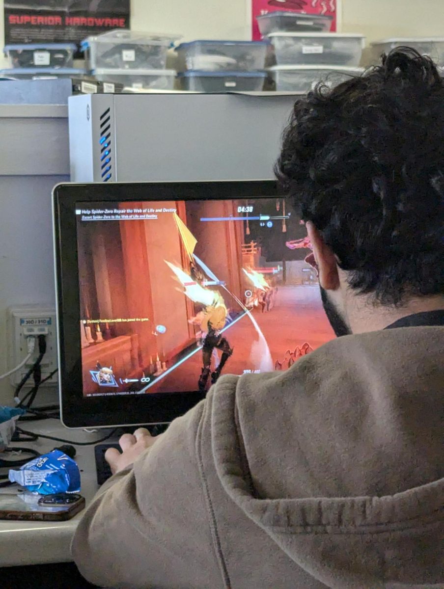 A Video Games Club member spends his meeting time playing Overwatch. Students can either play video games with others or by themselves.